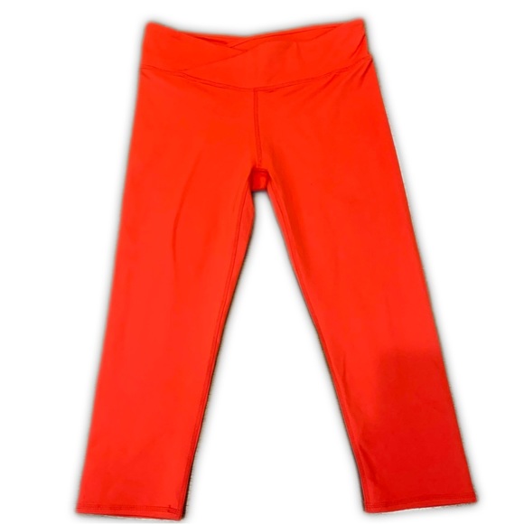 Fabletics Midrise Capris in orange with crossover waistband and hidden pocket - Picture 3 of 8